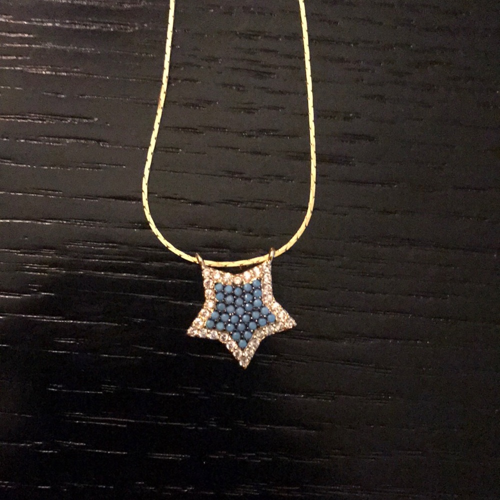 Gold chain necklace with blue and clear pave star